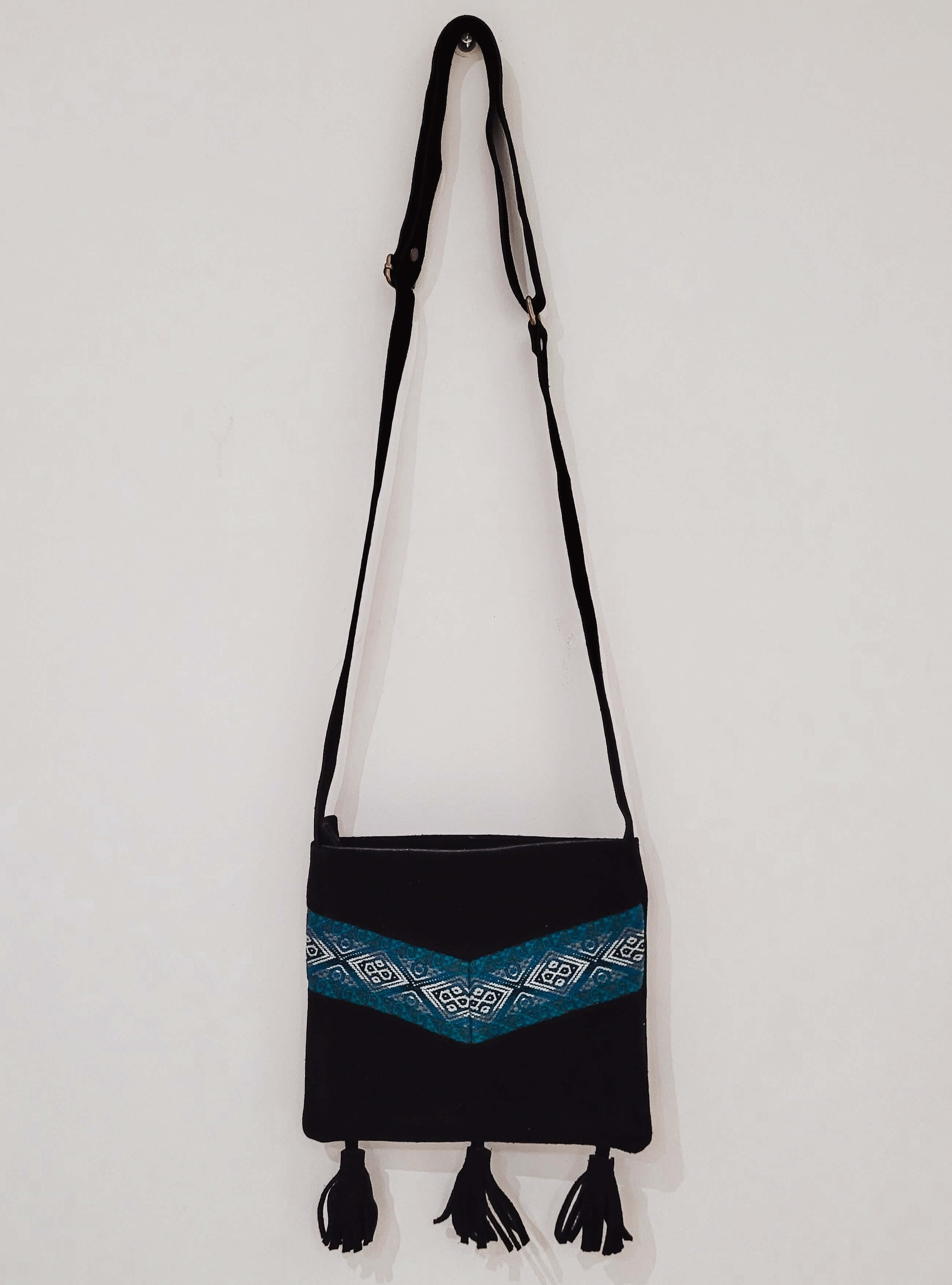 Leather Embroidered Handbag Azura on wall