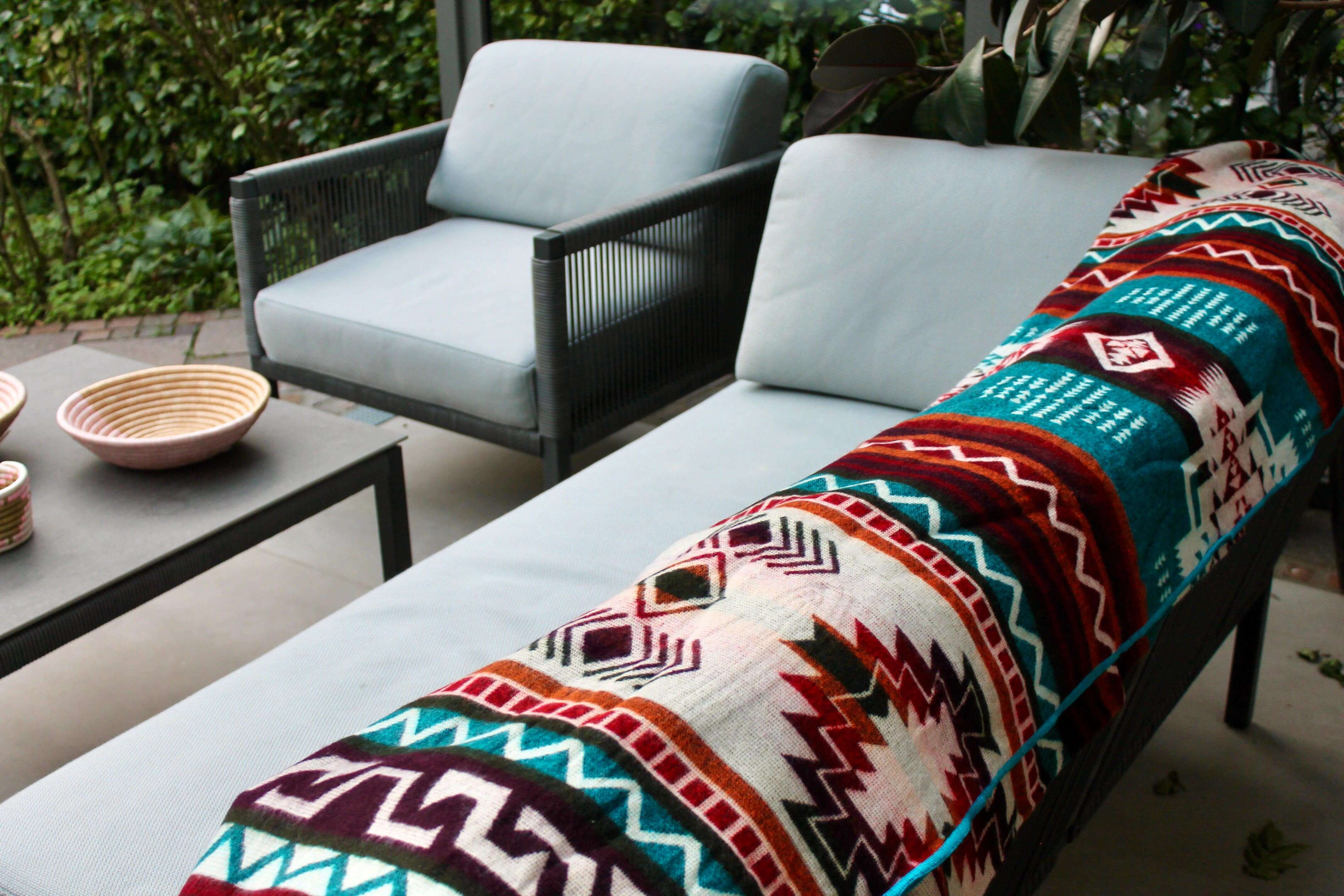Sustainable alpaca blanket on blue sofa